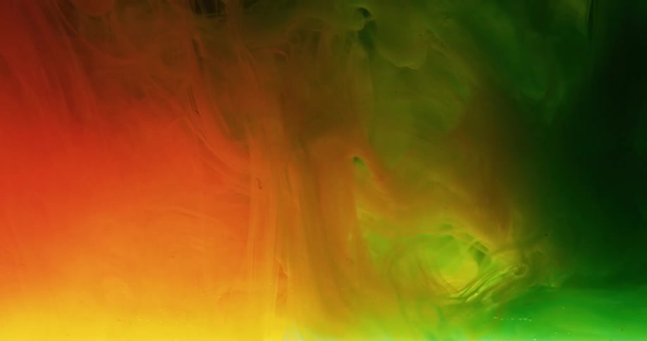 Glowing colors of green orange and yellow flow and swirl