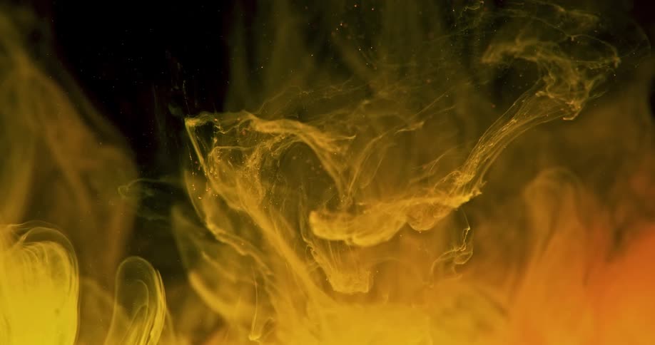Clouds of yellow and orange float in liquid