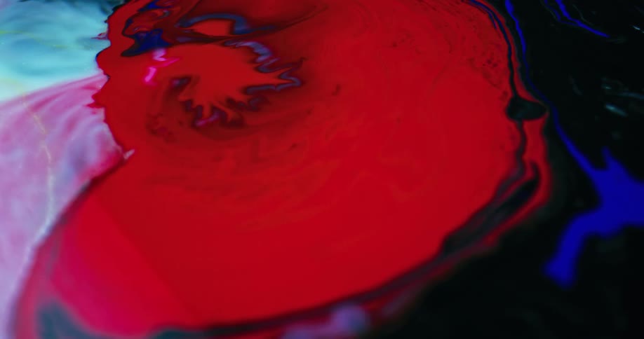 Bright colored fluids spread and swirl