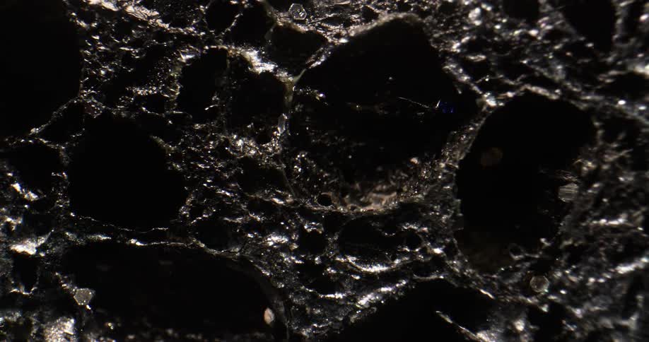 A close up of craters in tar