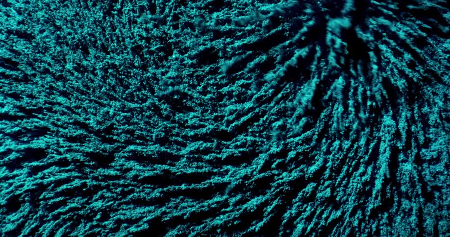A teal textured material under a microscope moving around in circles