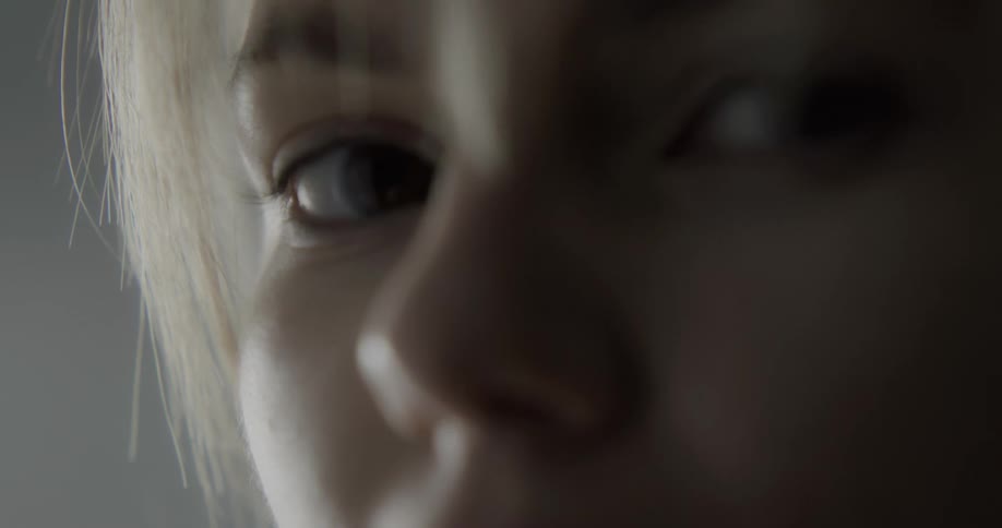 Blonde woman strokes finger down her lips