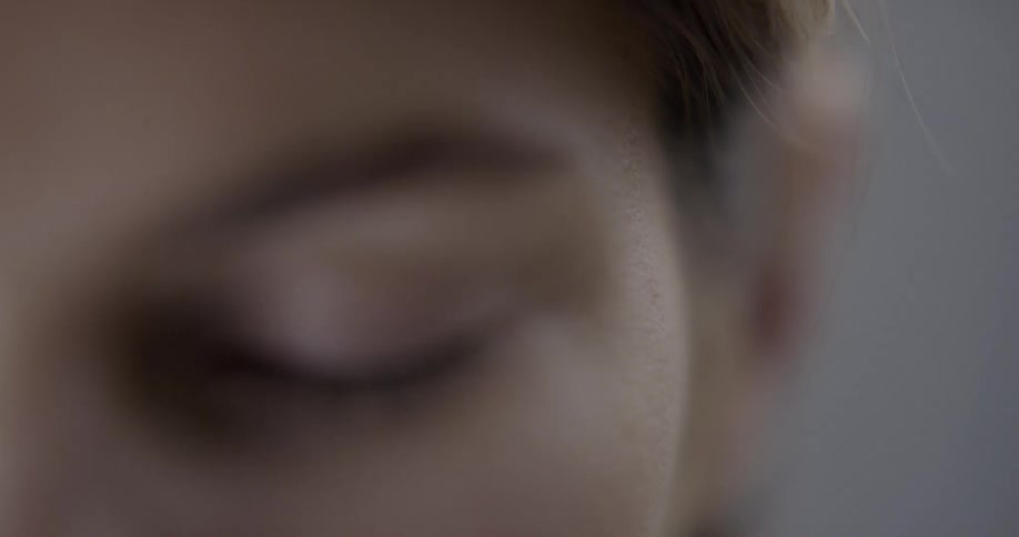 Close up of a womans eyelid eyebrow and back to her ear