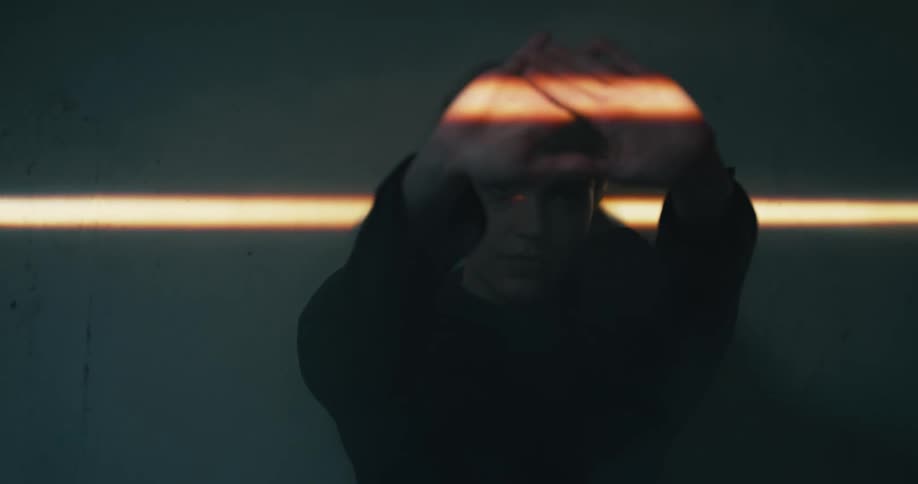 A woman blocking a ray of light with her hands