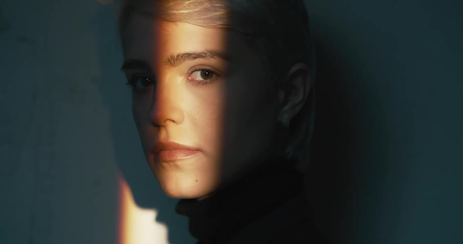 A woman looking into a ray of light