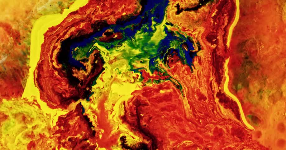 A mixture of different colors of paint are mixed together unevenly