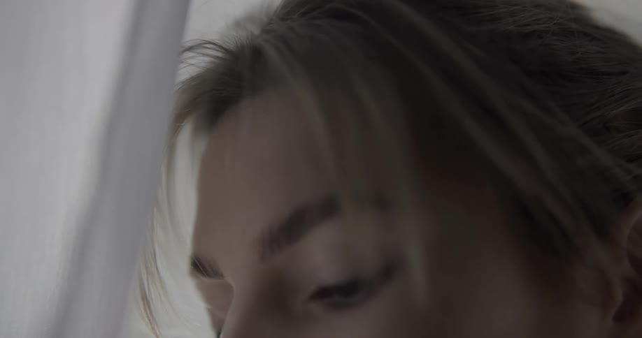 Close up of a woman running her fingers along her face