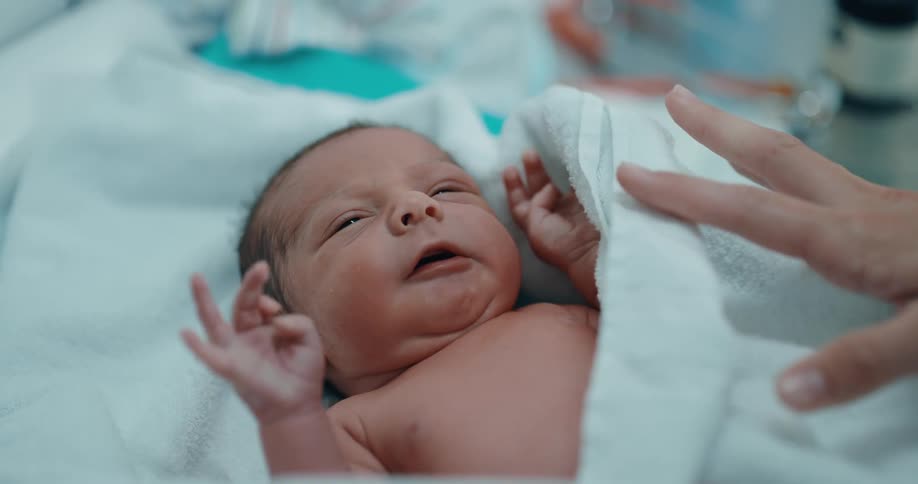 A baby wrapped in a towel