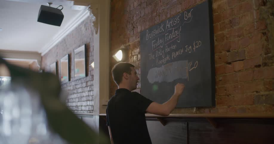 A man writing on a blackboard
