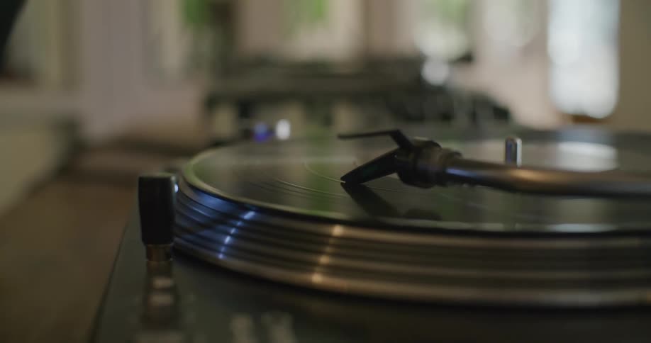 A vinyl record playing on a retro record player indoors