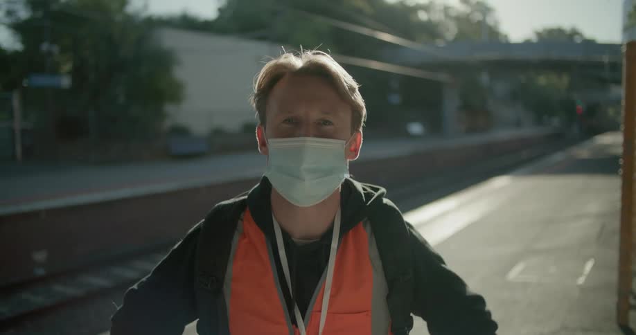 A man putting on a mask