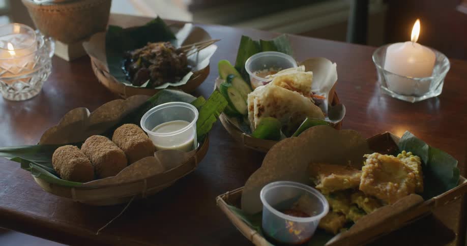 A table with plates of food and candles