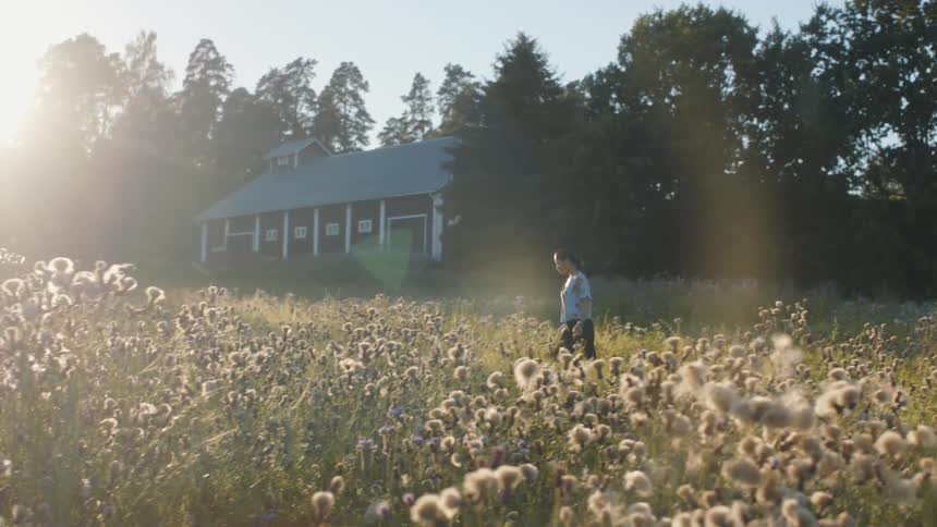 Woman strolling through rural field outside
