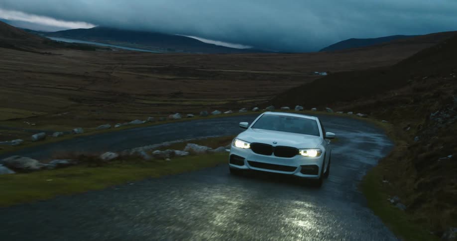 A car driving up a hilly road