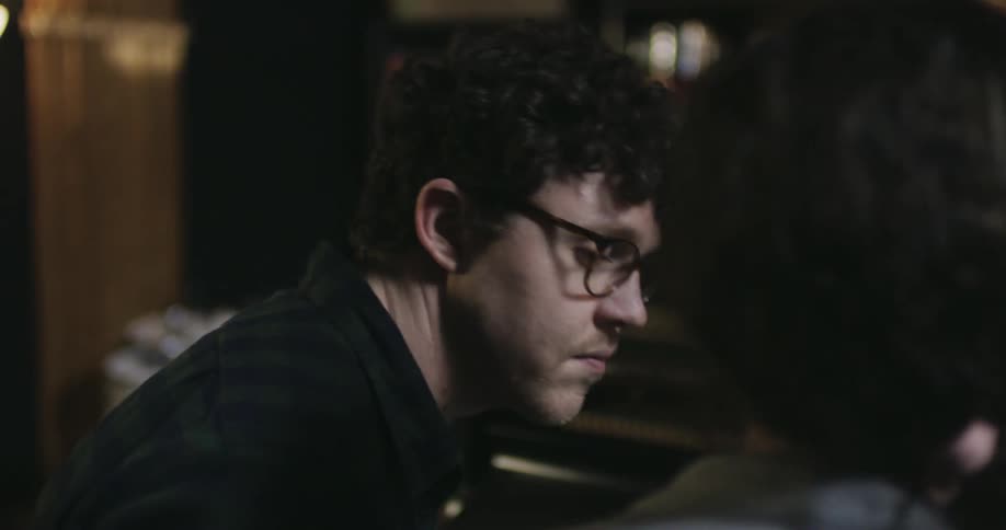 Someone sits near a man and they begin to talk