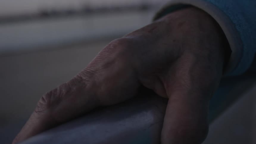 Close up of a hand on a railing
