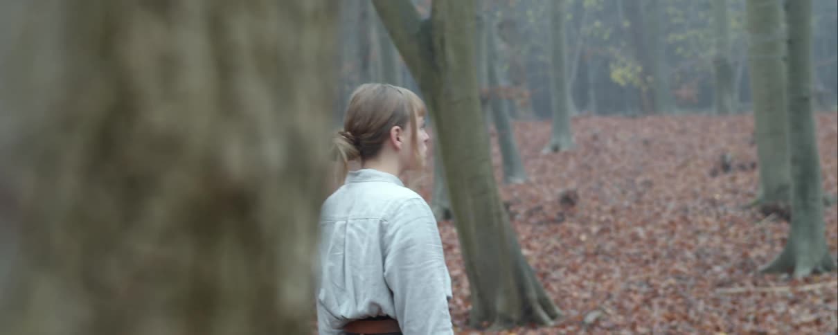 A woman standing in a forest