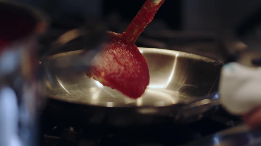 Sauce being put in a pan
