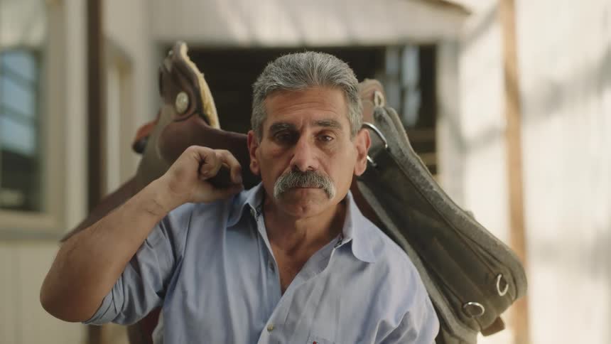 A man holding a bag over his shoulder