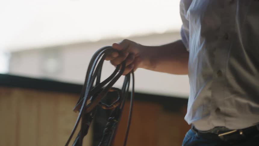 A man walking down a hall with a rope