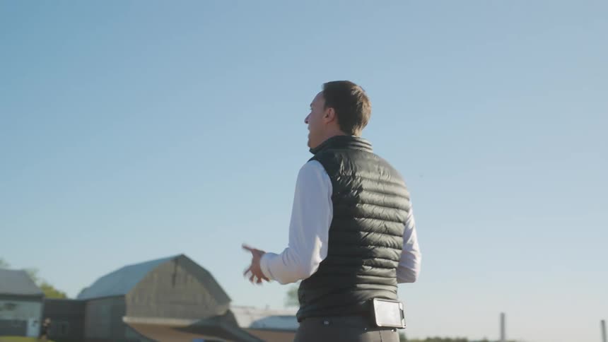 A man talks as he walks on the farm