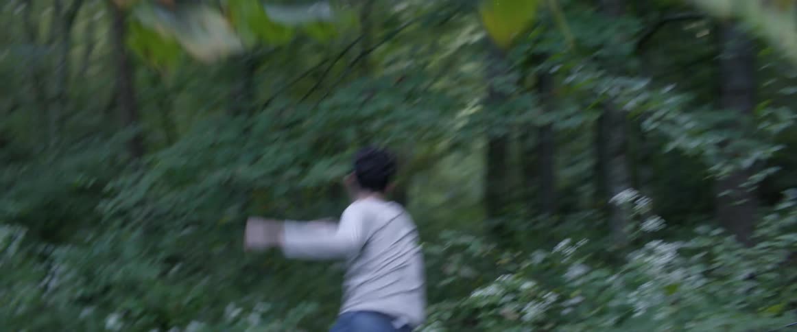 A man is fleeing into the forest