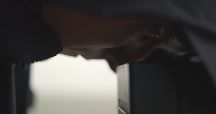 Close up of the face of a photographer looking through the viewfinder of a camera