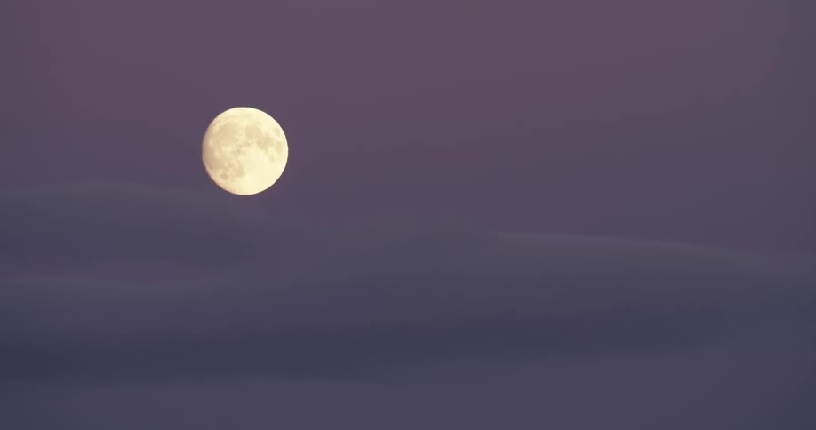 A full moon glowing in a purple night sky
