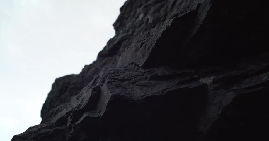 Rocky cliff wall texture with sky visible