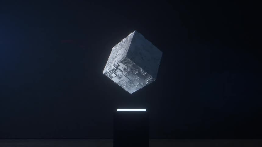 Abstract digital cube is displayed in a dark museum