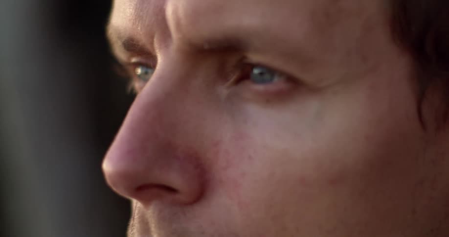 A man staring off into the distance with his eyes