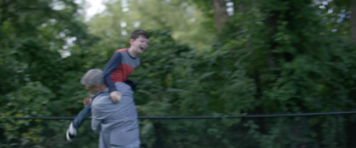 Father and son playing on the backyard at home in the evening