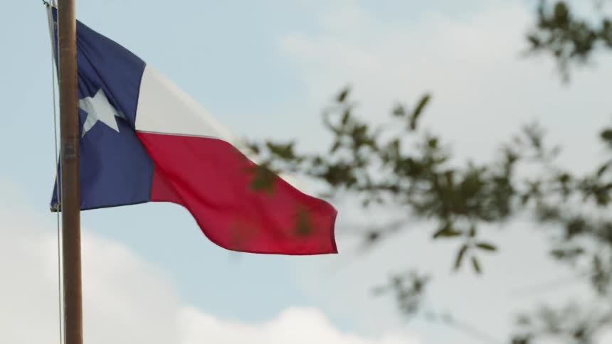 The wind is blowing the flag in the sky
