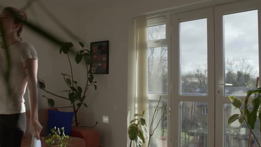Young woman reading a notebook memorizing a lesson out loud at home