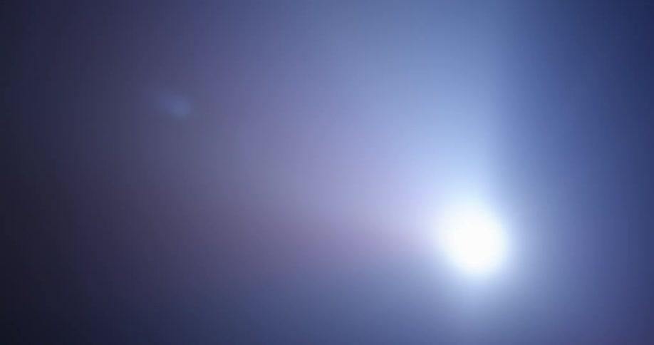 A bright light being moved around in the darkness