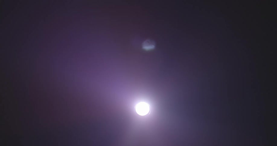 Beams of light flash around a sphere of bright light