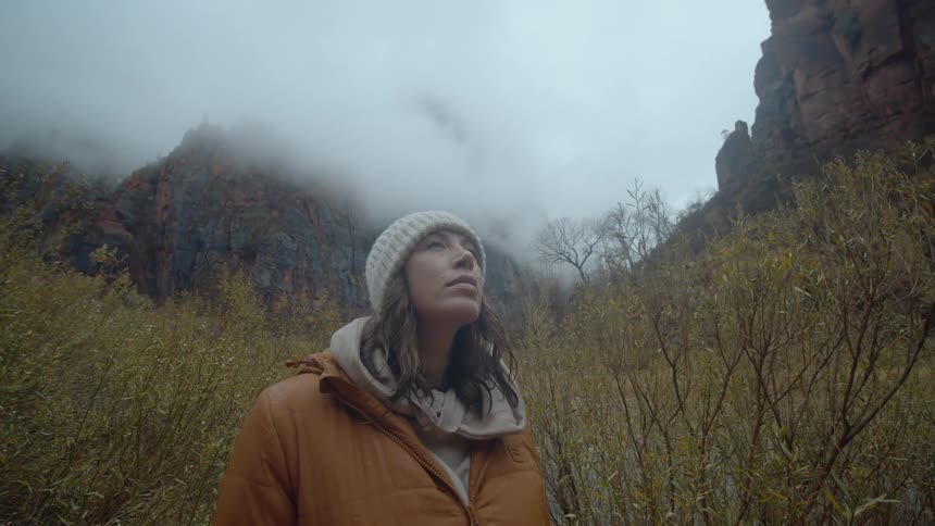 A woman is hiking outdoors in fall