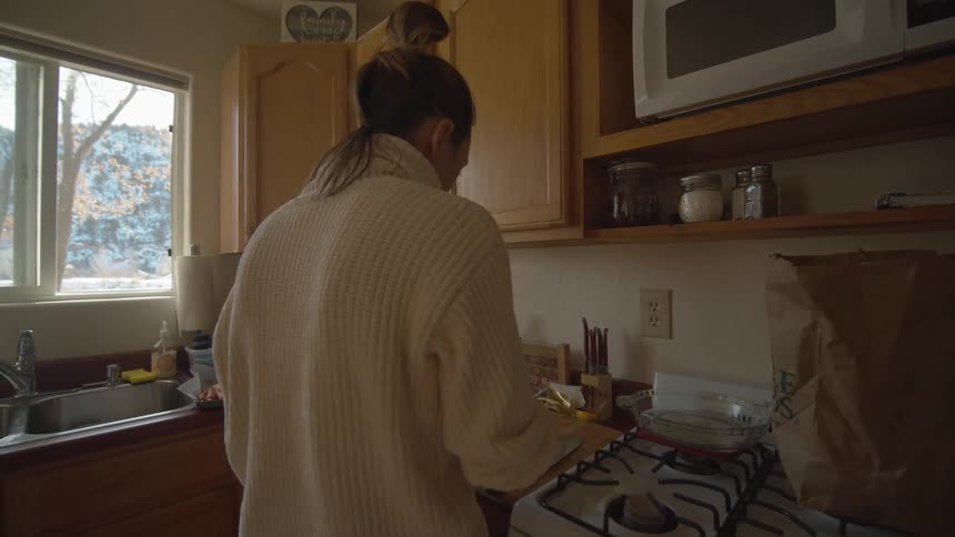 A woman is cooking in the kitchen