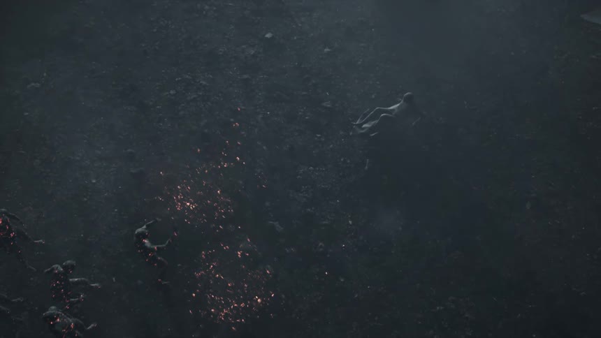 A man on the floor scoots away from human ember like figures moving towards him