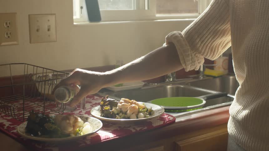 A woman is preparing food in her kitchen