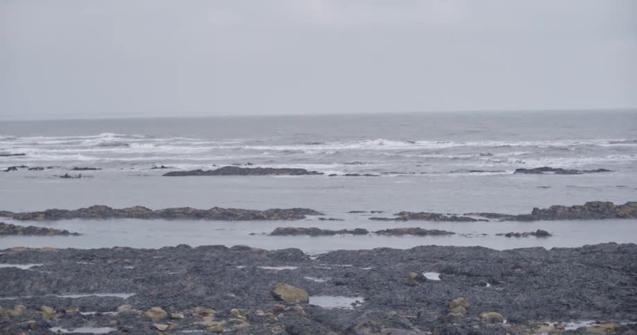 Waves roll in on a rocky coastal shoreline