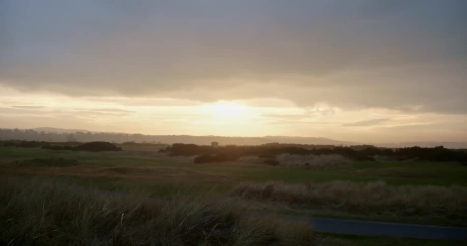 The sun is setting in a rural area
