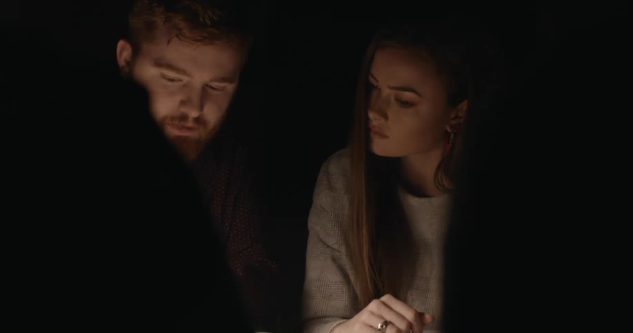 Two teenagers sit and study together