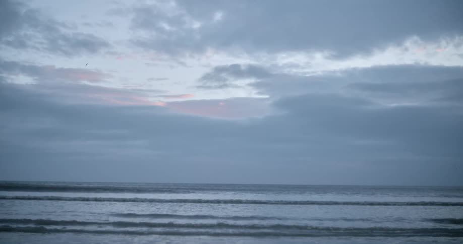 Waves roll in on the coast on a cloudy day