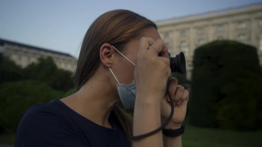 A woman taking a photo with a camera