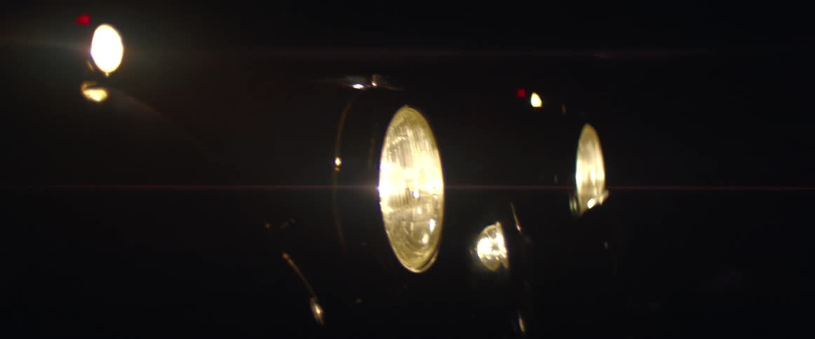 A vehicle driving with the headlights on