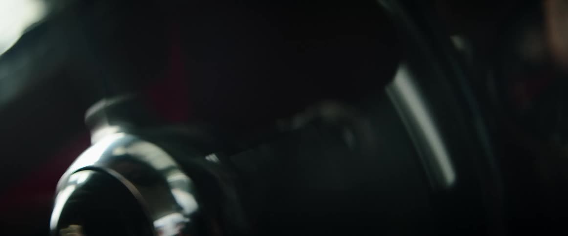 Close up of a persons hands on a steering wheel as they race a car