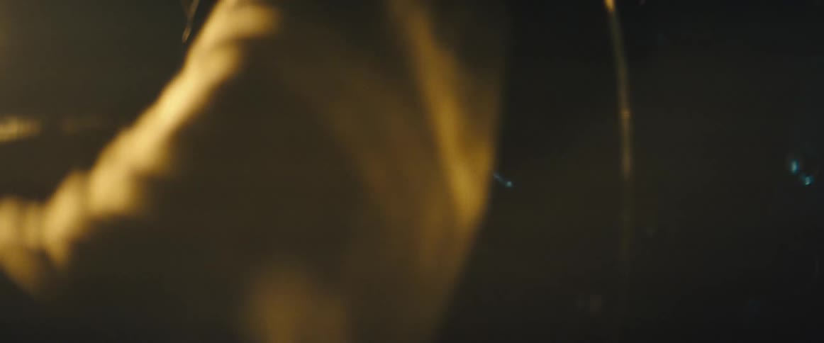 Close up of hands driving the steering wheel of a car at night