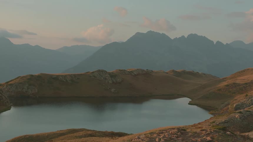 A lake surrounded by mountains in the morning