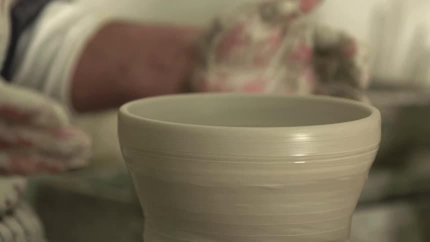 A man hand turning pottery on a wheel